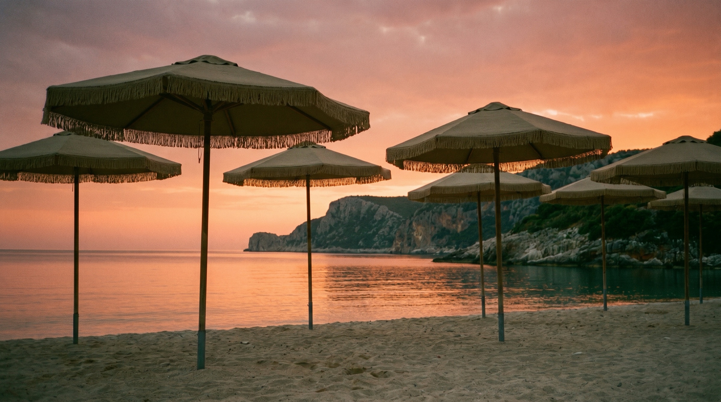 Beach umbrellas at sunset on the Albanian Riviera