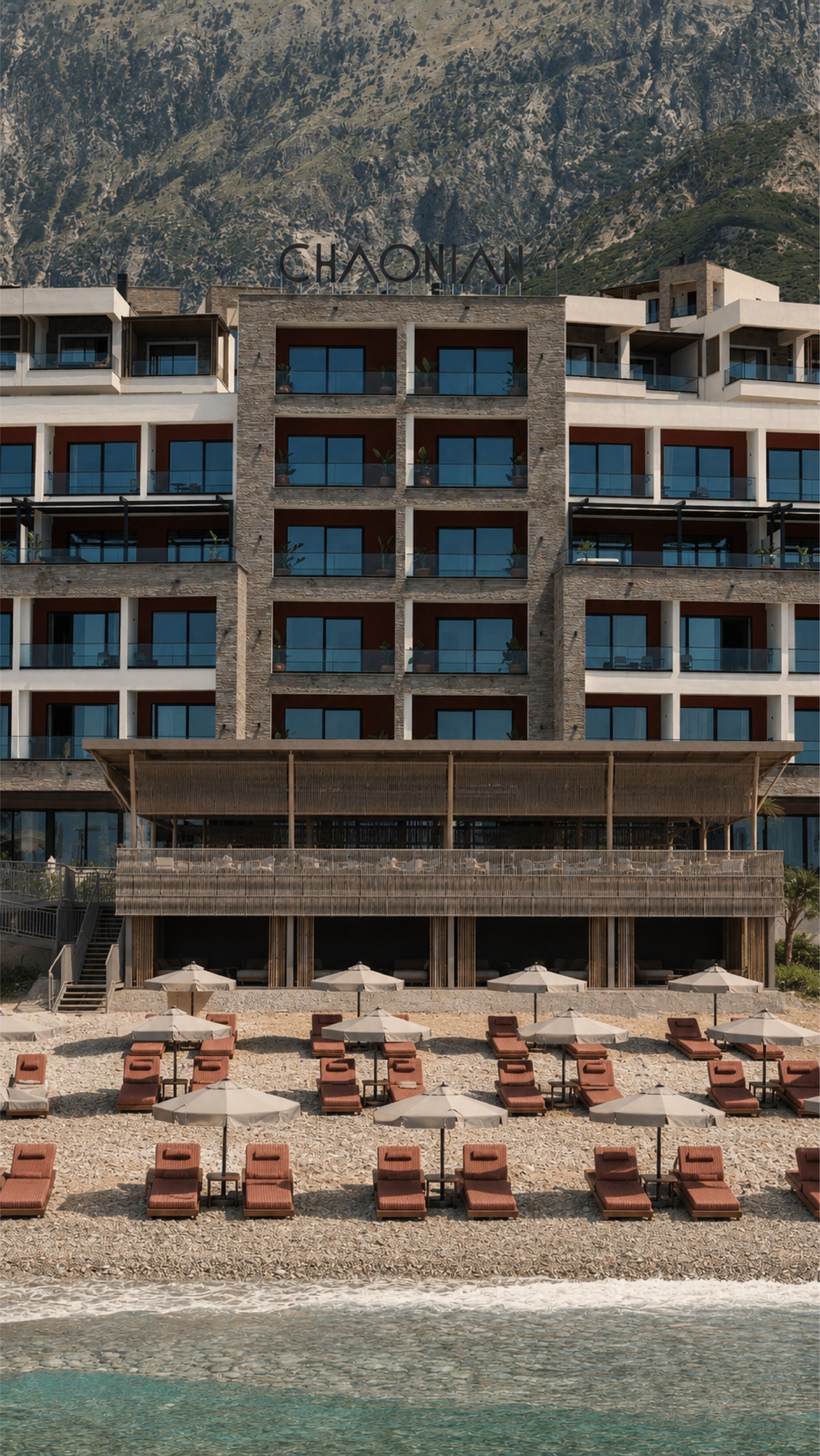 Chaonian Hotel — the beach bar and hotel seen from the water, loungers along the shore