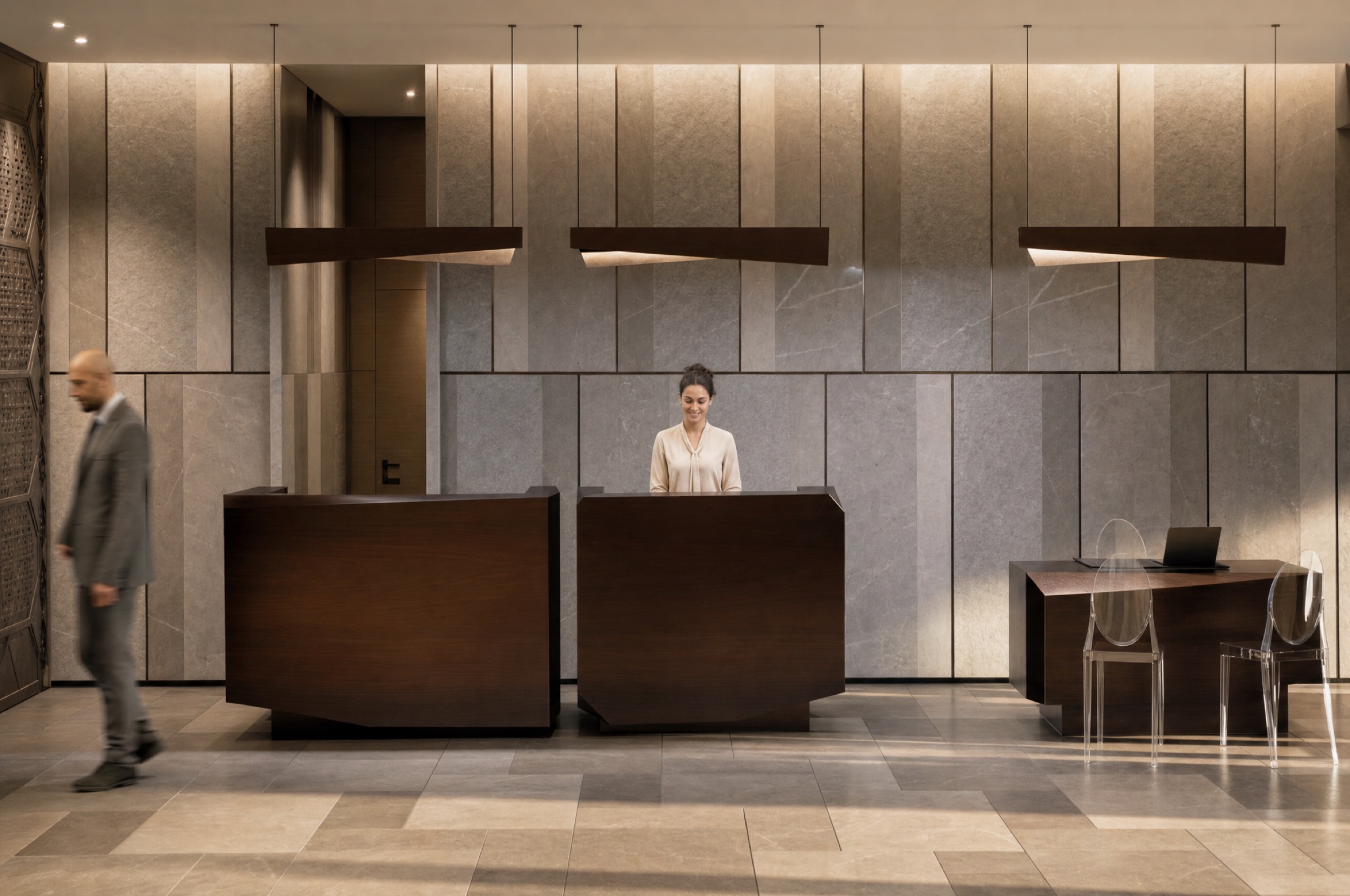 A Chaonian receptionist smiling behind the marble-and-walnut reception counter
